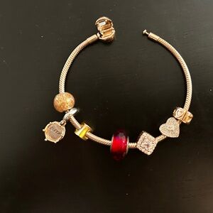 Elegant Silver Charm Bracelet with Red and Gold Accents